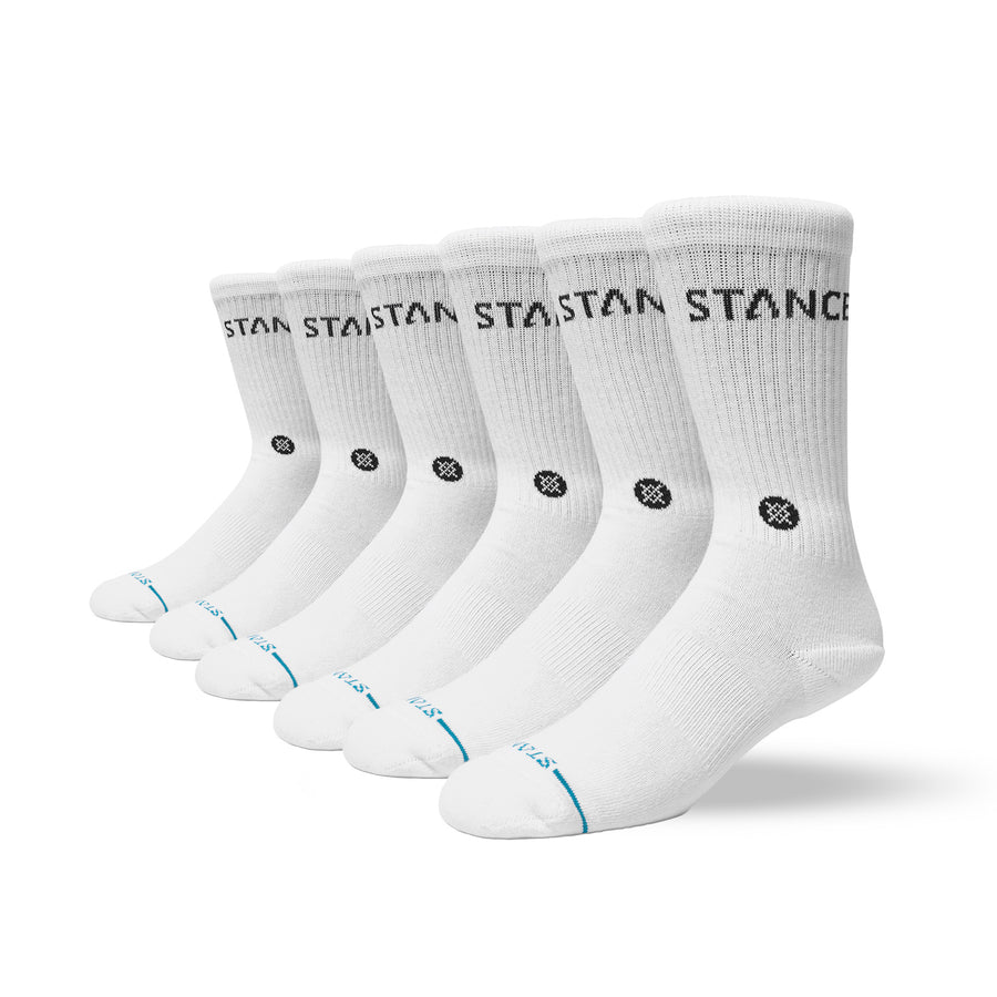 Set of six white stances socks with black branding on a white background