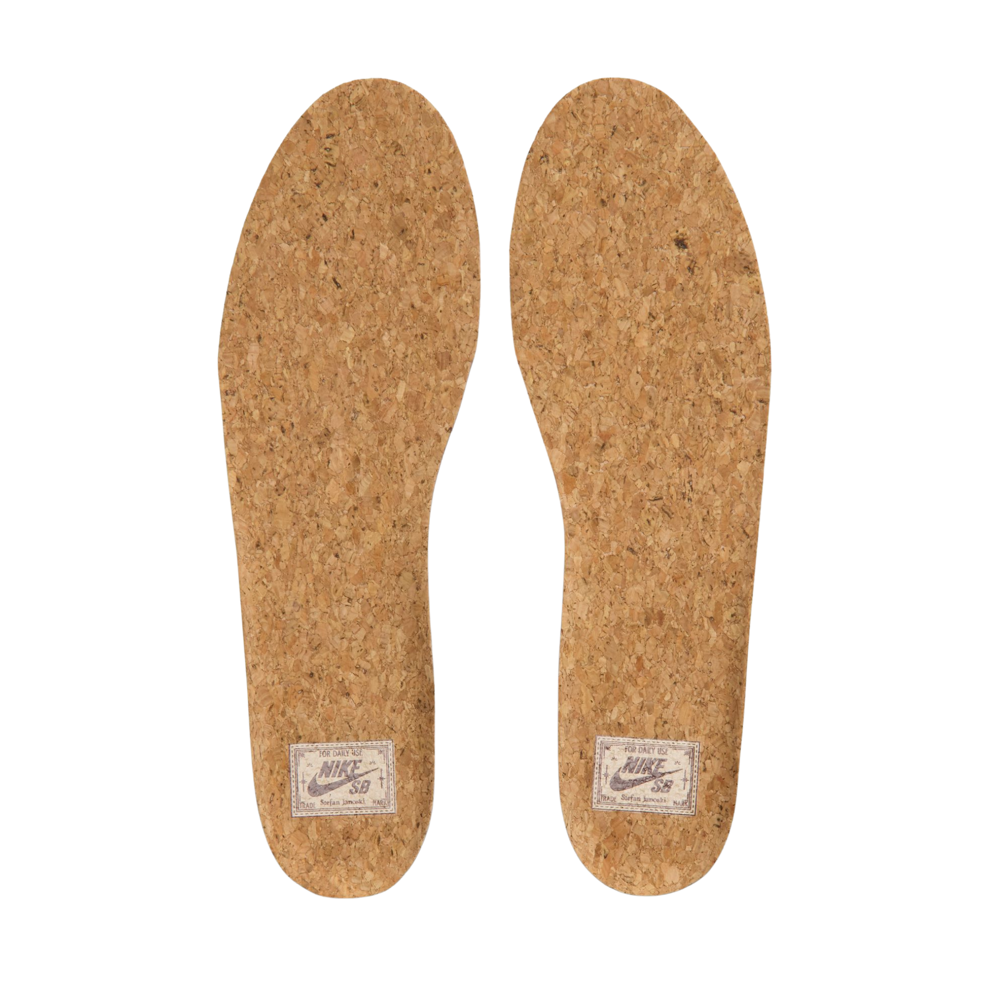 A Nike sb janoski low-top sneaker in a light beige suede and canvas mix, featuring a dark brown Swoosh logo, matching brown laces, and a thick white rubber sole.
