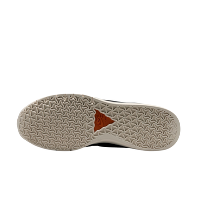 The outsole ofA Nike SB PS8 skateboard sneaker in black, orange, and gray leopard print, photographed on a solid white background.