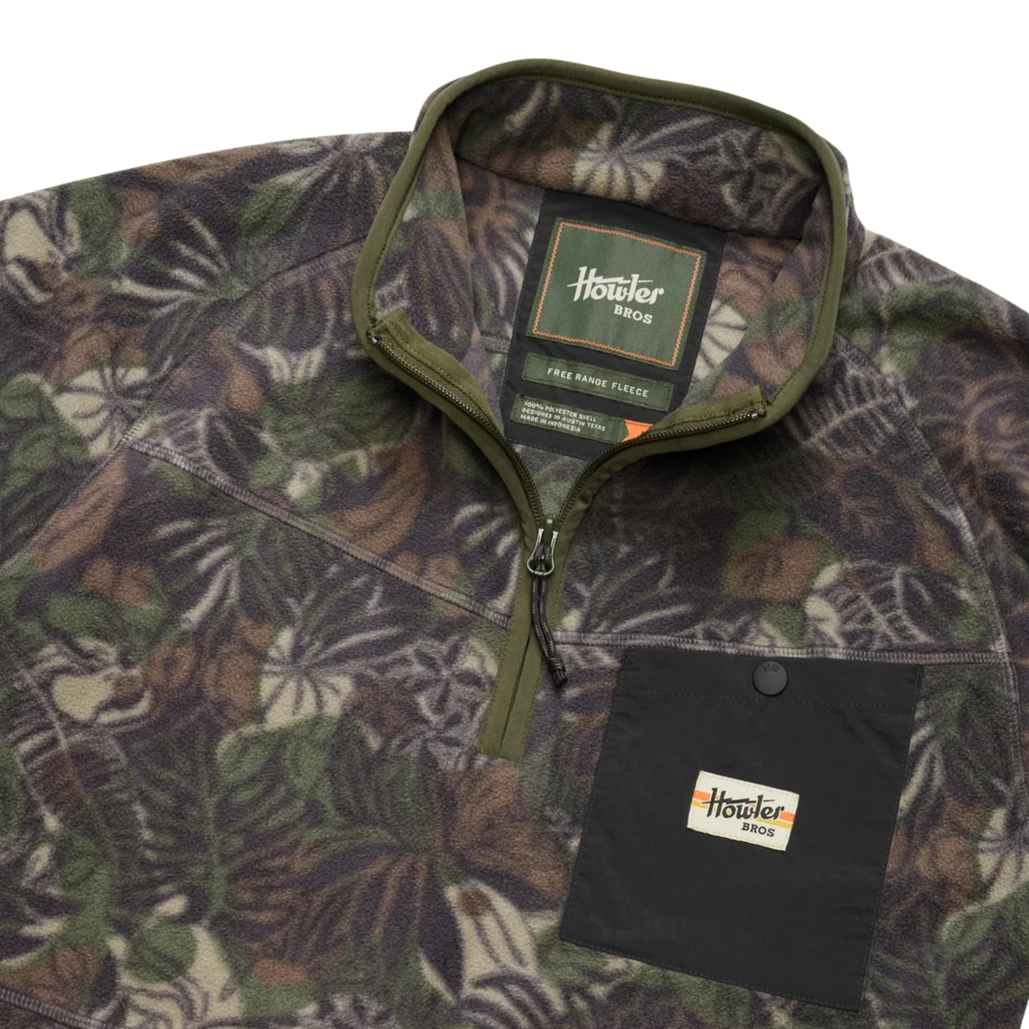 a close up of A long-sleeve quarter-zip howler brothers pullover fleece, featuring a dark green and brown tropical leaf camouflage pattern. It has a black chest pocket with a white and red Howler logo patch, a stand-up collar, and zippered hand pockets.