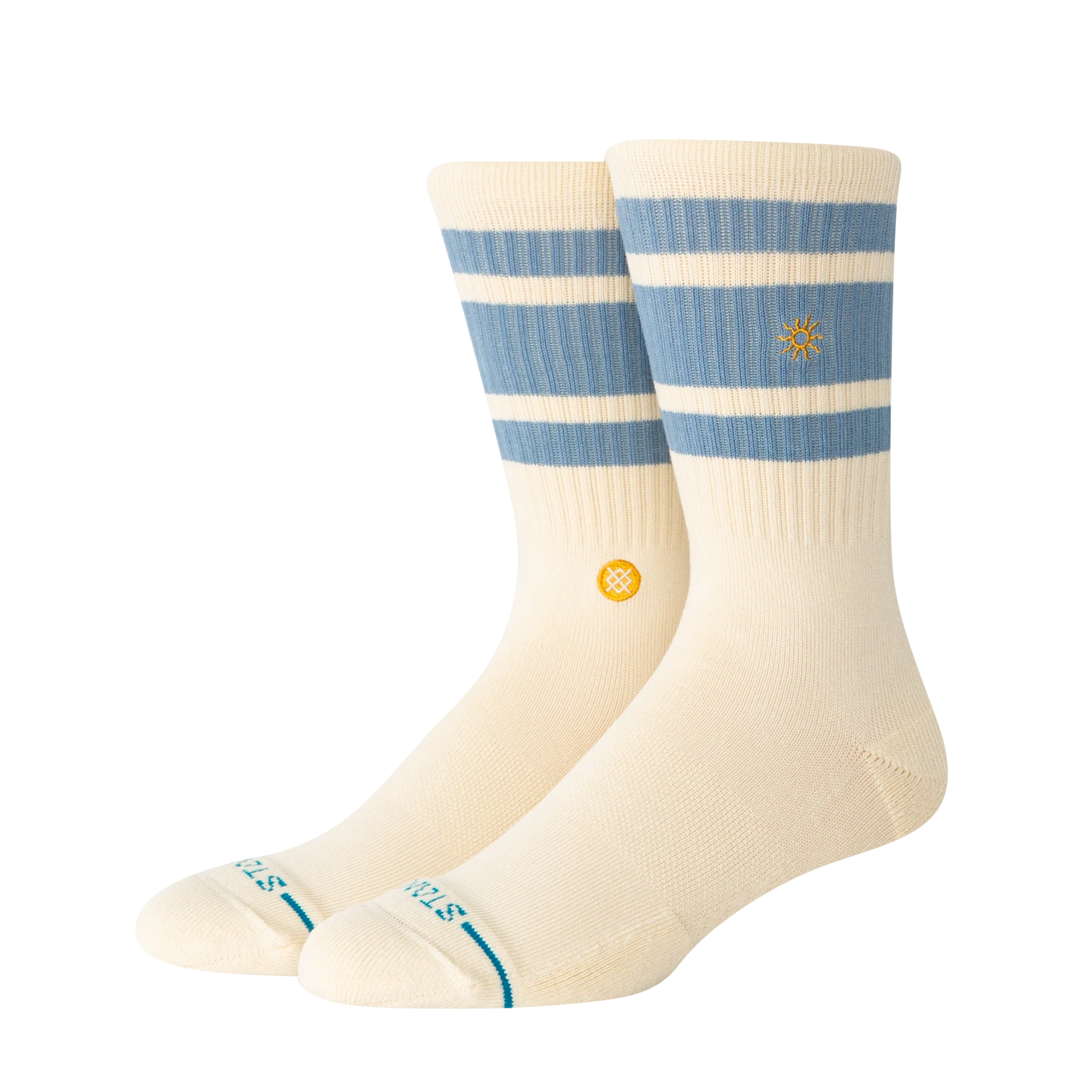 A pair of Stance got sol crew socks in cream with light blue horizontal stripes near the cuff, a small yellow logo on the side, and teal lettering on the toes, shown against a plain white background.