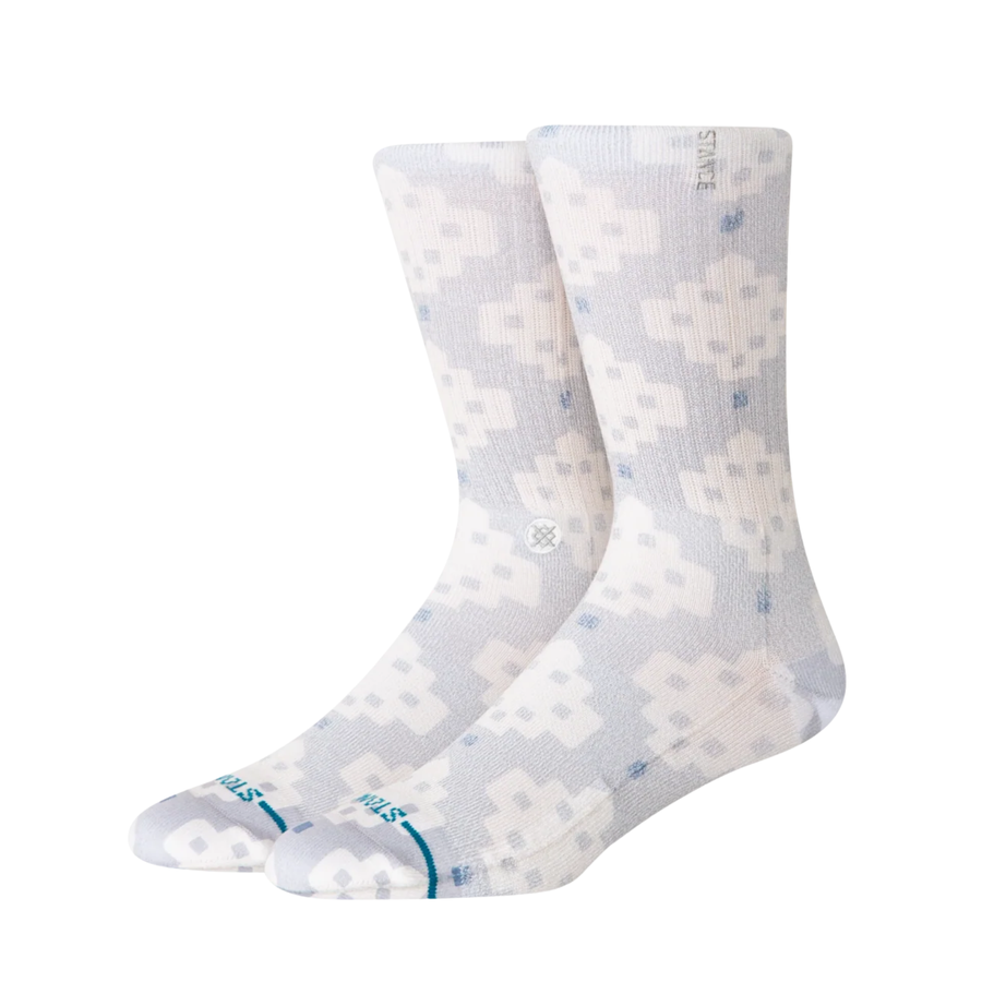 A pair of Stance alhambra butterblend crew socks with a light gray and white pixelated geometric pattern, featuring a small blue logo and 'STANCE' branding on the toes.