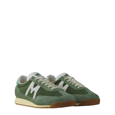 Green karhu flower pack mestari men's sneaker with a white 'M' logo on a white background