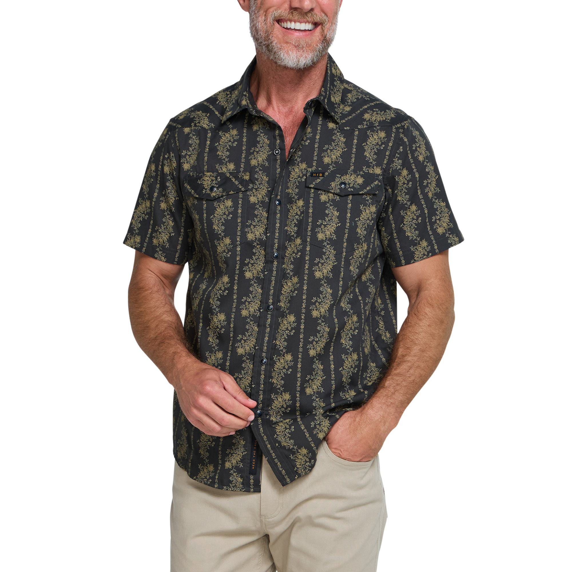 a man wearing a Holwer Brothers H Bar B Snapshirt grampa's curtains in a black with a gold floral design on a white background