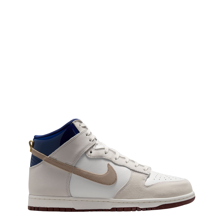 A Nike SB X Beyond Skate Shop Dunk High sneaker in off-white leather with a beige Swoosh, a blue collar lining, and a brown gum outsole, shown from a side profile on a white background.