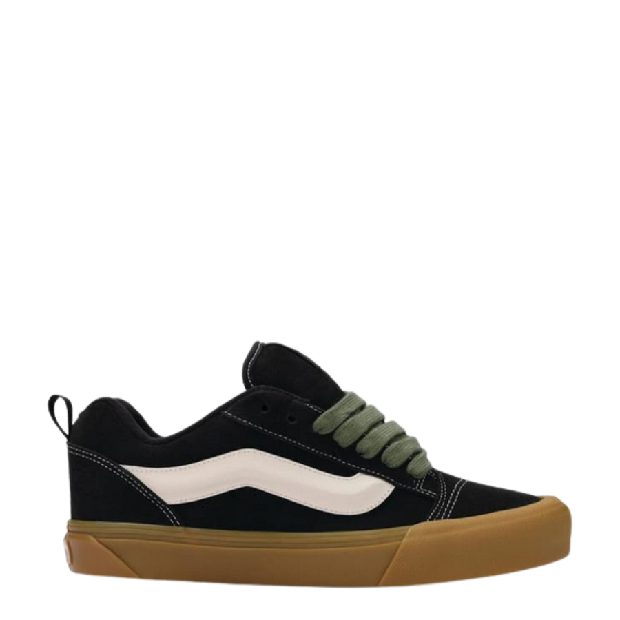vans Black knu skool sneaker with white stripe, green laces and brown sole on a white background