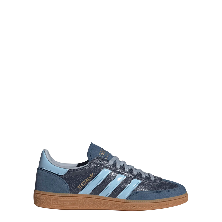 A single Adidas handball spezial sneaker in navy blue suede and textured leather, featuring light blue stripes, a light blue heel tab, and a brown gum sole, shown against a plain white background.