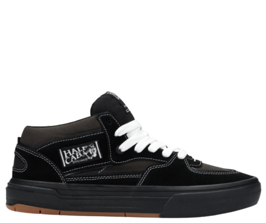 Black  vans united by skateboarding half cab mid-top sneaker with white laces on a white background