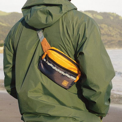 Multicolored thread belt bag with a visible brand logo on a white background