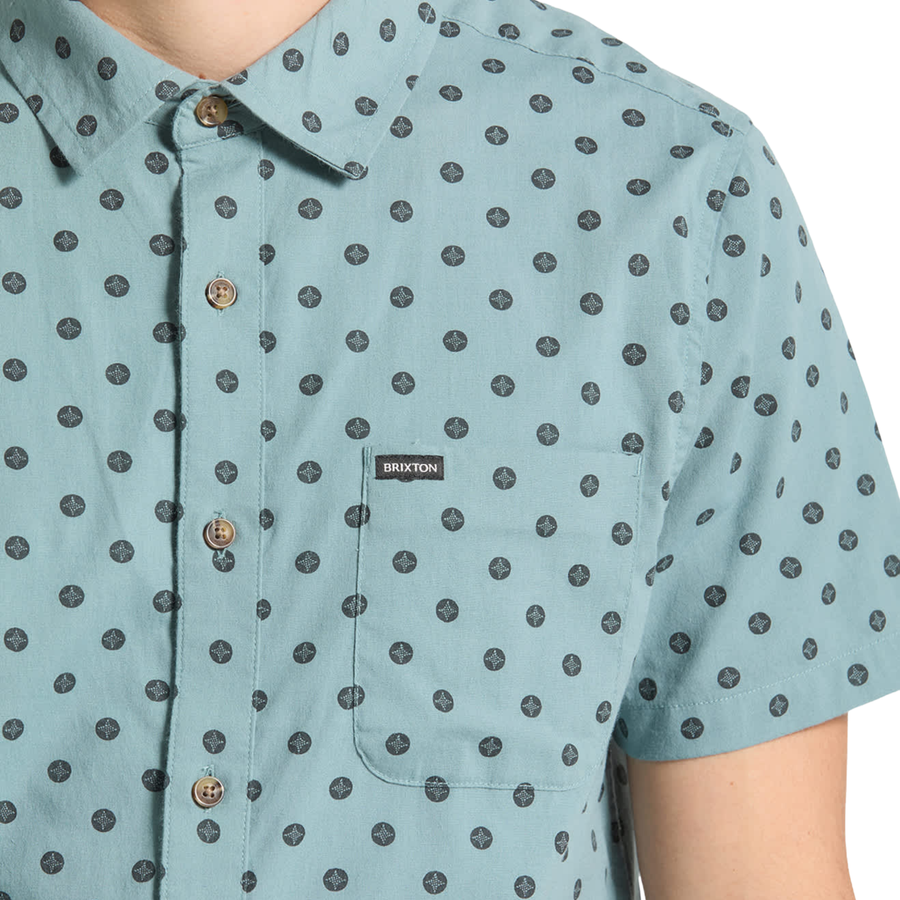 blue brixton charter print short sleeve woven men's shirt with contrast pattern on a person