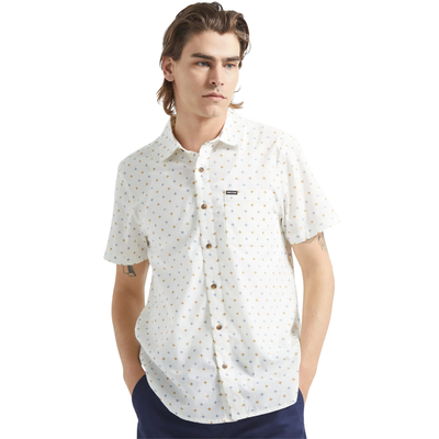 Man wearing a white brixton charter print short-sleeve shirt with a subtle pattern on a white background