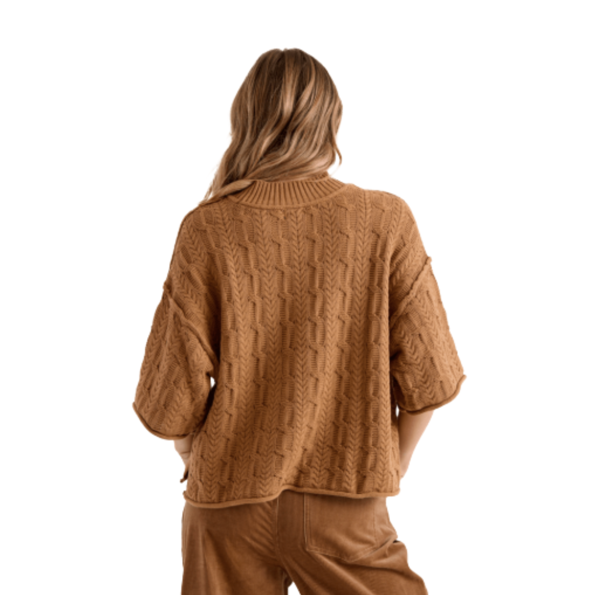 A woman wearing a brown volcom oversized cable-knit mock-neck sweater and matching brown corduroy pants, shown against a plain white background.