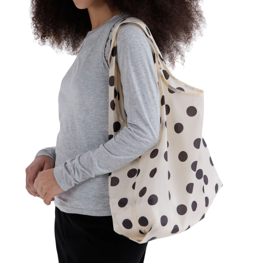 cream colored standard baggu reusable tote with black polka dots on a white backgroun