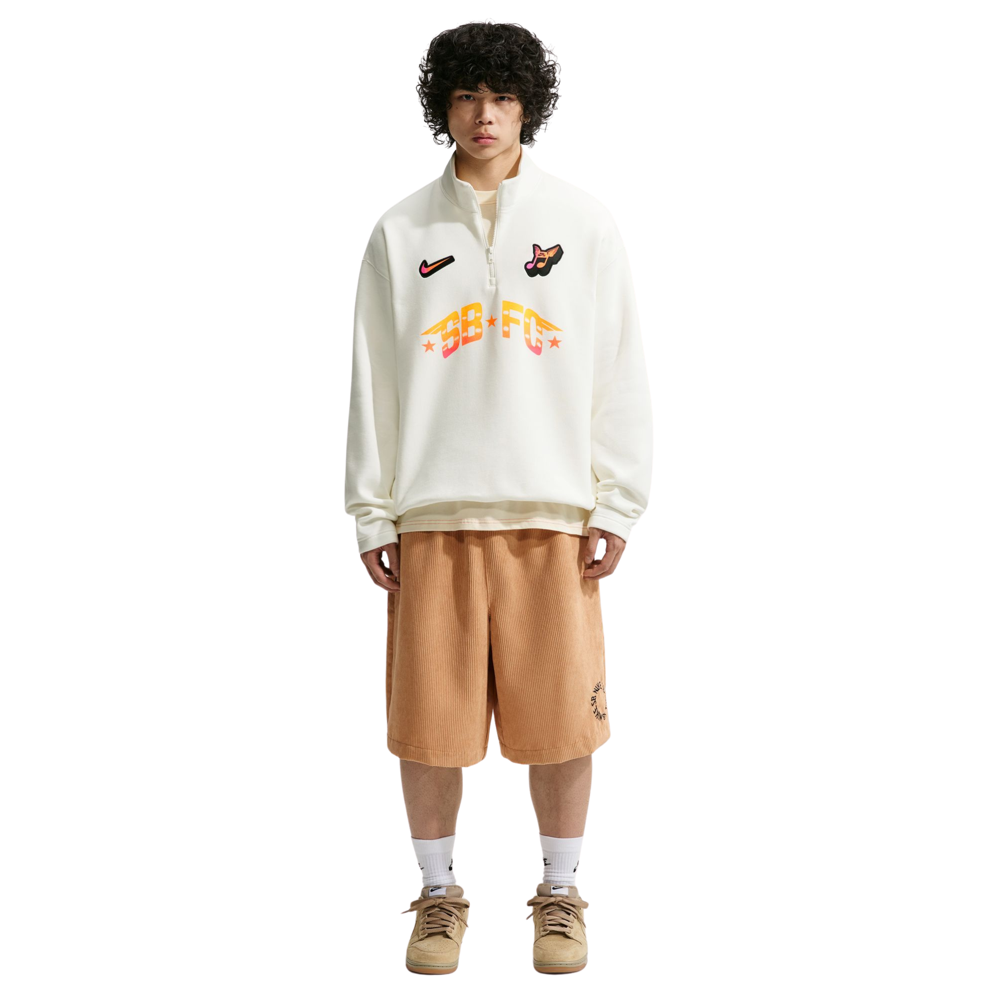 person wearing white half-zip NIKE SB FC PACKsweatshirts with logos and text on a white background