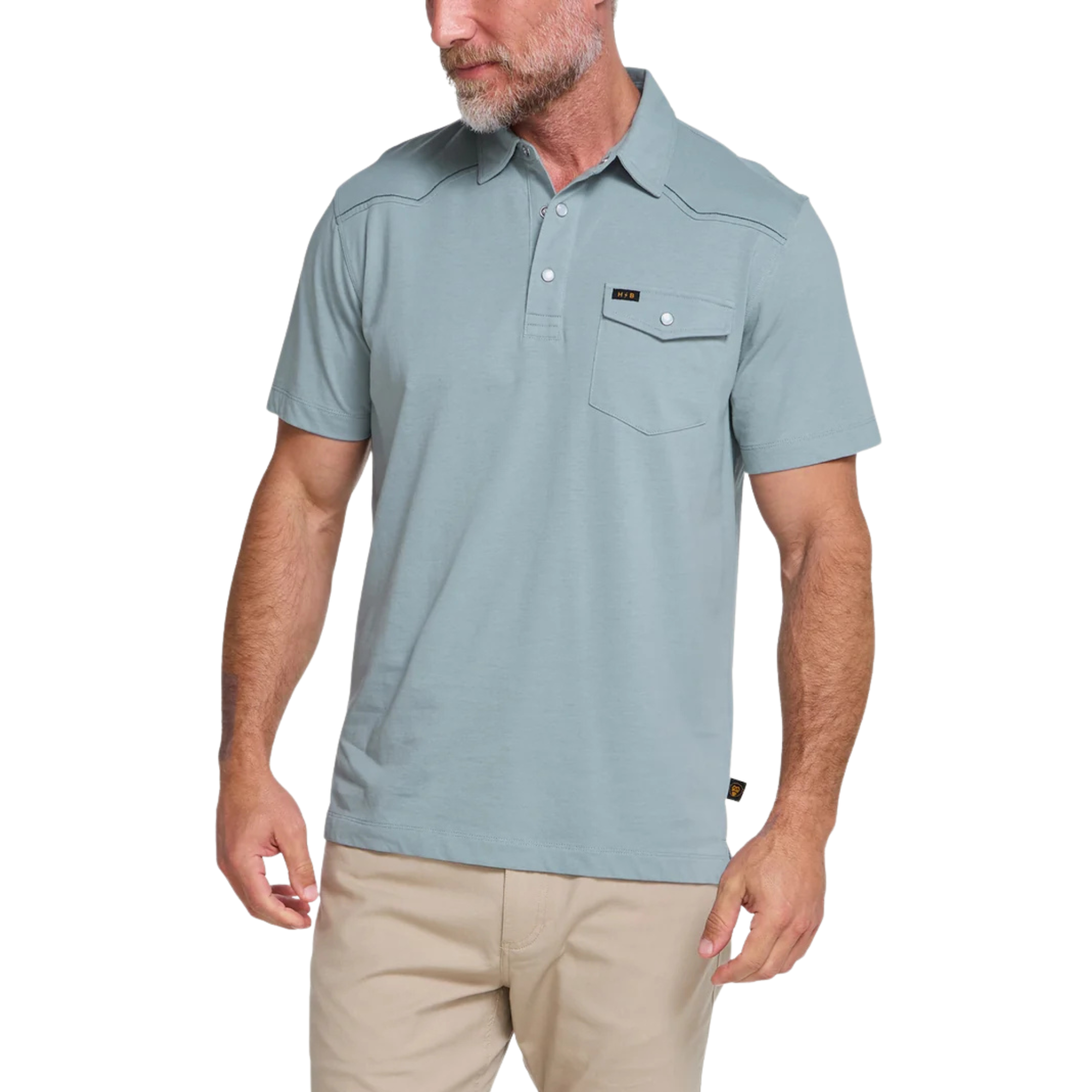 A light blue short-sleeve Howler brothers ranchero polo shirt with western-style stitching, a two-button placket, and a chest pocket, shown flat on a white background.