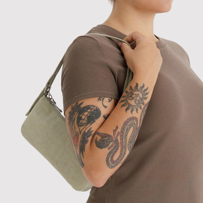 light green baggu handbag with a strap on a person