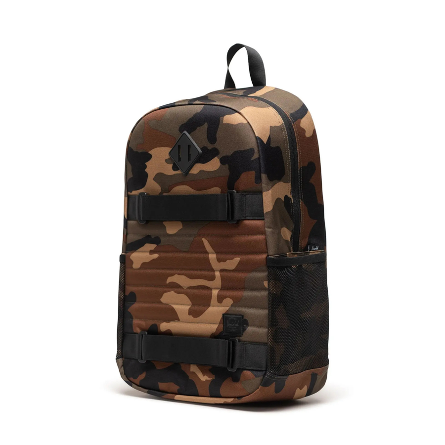 camo herschel fleet skateboard backpack on a white background