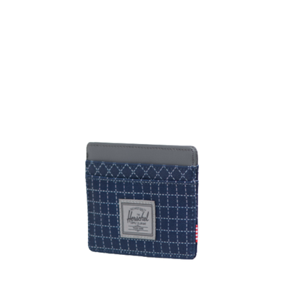 blue herschel charlie card wallet with grid pattern on a white background