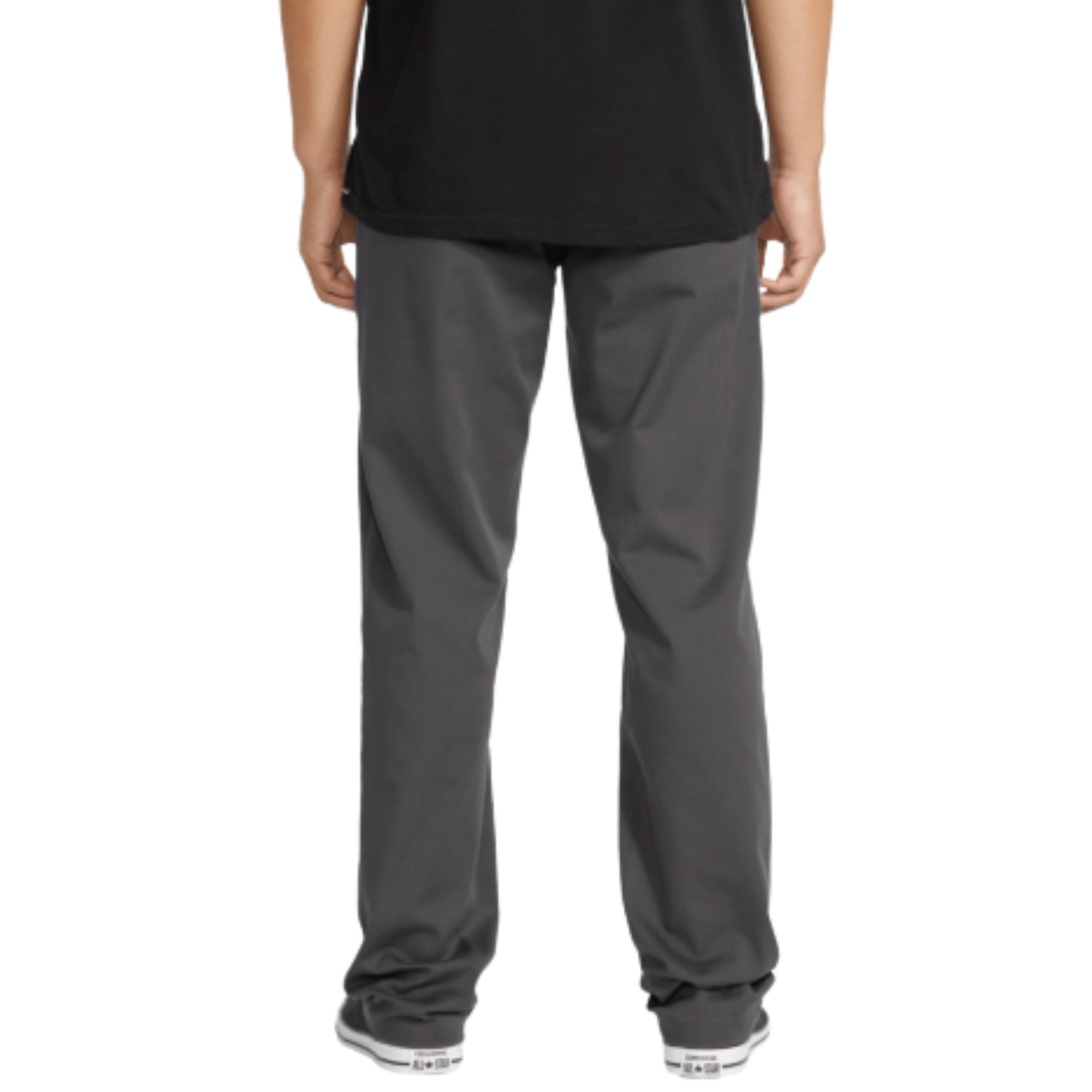 A person wearing dark gray volcom frickin stretch chino pants straight-leg work pants, a black t-shirt, and black canvas sneakers, shown from the waist down against a plain white background.