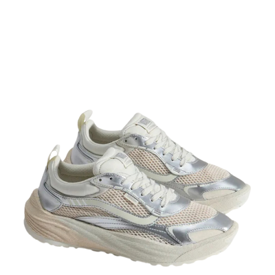 A pair of low-top vans ultrarange neo 2.0 sneaker shown in profile against a solid white background. The shoe features a cream-colored knit upper with metallic silver overlays, a chunky cream midsole, and white laces.