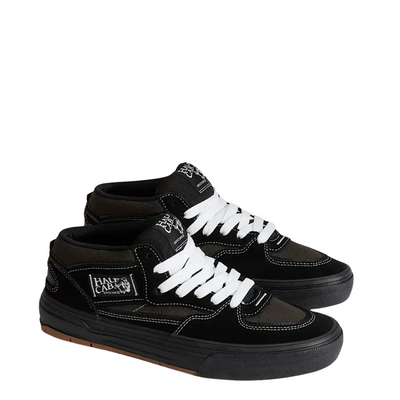 Black  vans united by skateboarding half cab mid-top sneaker with white laces on a white background