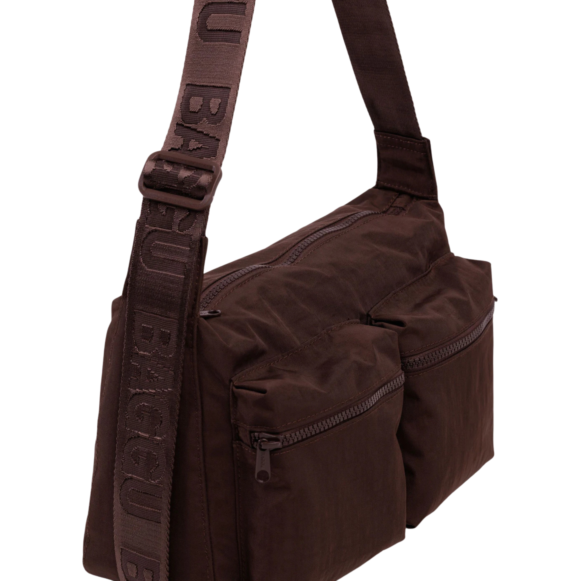 A dark brown baggu cargo crossbody bag with dual front zippered pockets and a wide, patterned shoulder strap, shown against a plain white background.