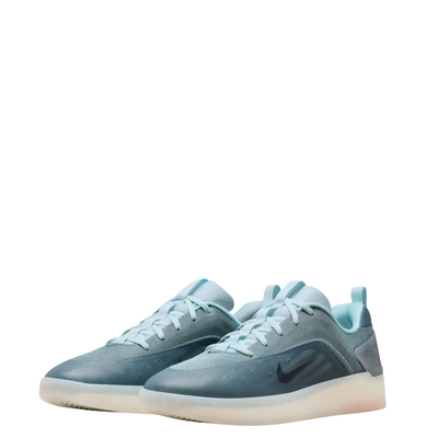 Blue nike sb zoom nyjah 4 skateboard sneaker with a white sole on a white background