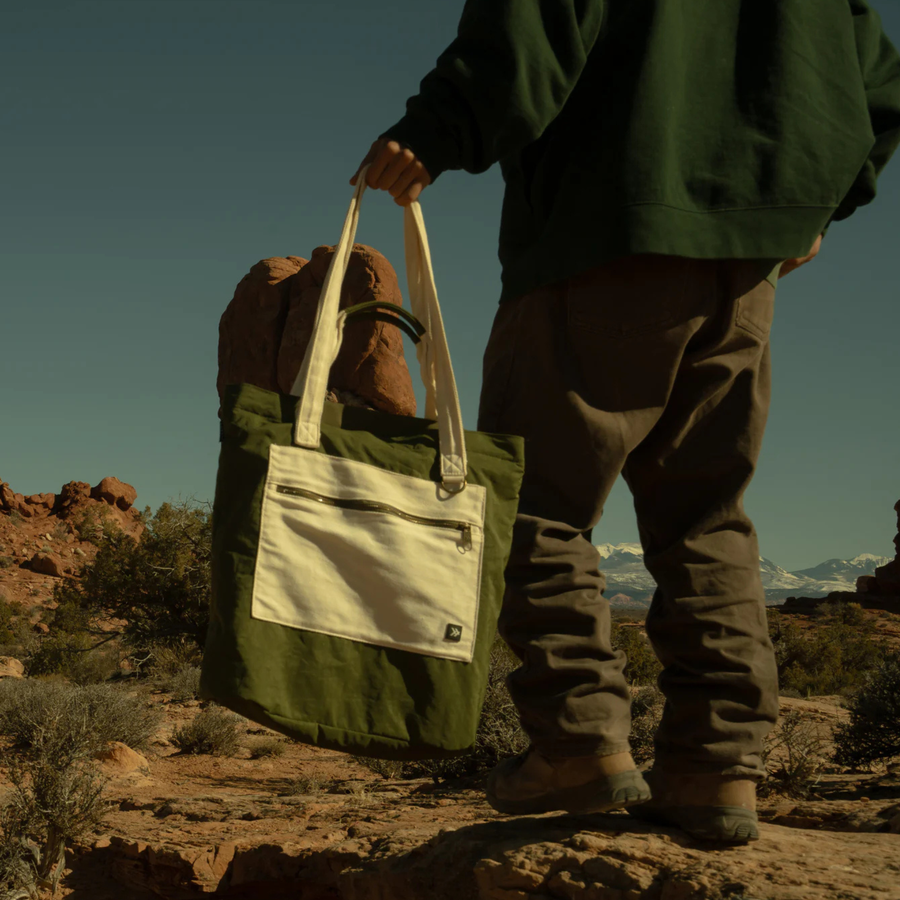 Green thread scout tote bag with a white pocket and strap on a white background