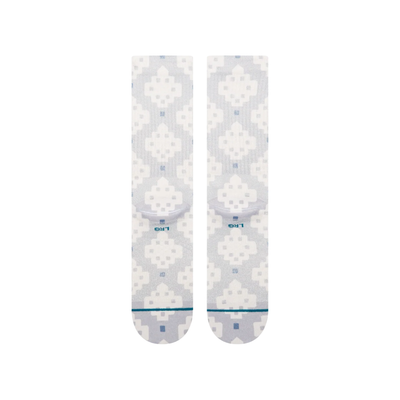 A pair of Stance alhambra butterblend crew socks with a light gray and white pixelated geometric pattern, featuring a small blue logo and 'STANCE' branding on the toes.