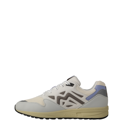 A low-top Legacy 96 sneaker by KARHU in light gray and off-white, featuring a lavender purple heel accent, dark gray side stripes, and a beige midsole.