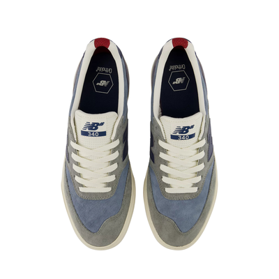 A pair of New Balance 340 sneakers shown from a top-down view. The shoes feature a mix of light blue suede, gray suede, off-white leather, and navy blue accents, with a small red tab at the collar.