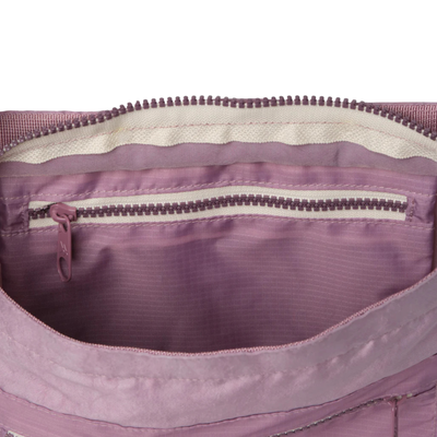 inside of a pink thread tote bag on a white background