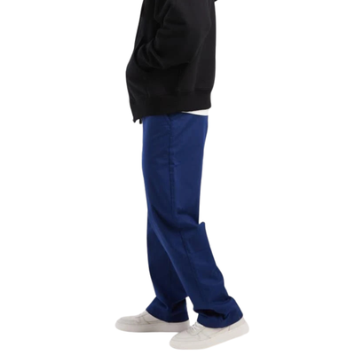 Person wearing blue vans pants and a black jacket on a white background