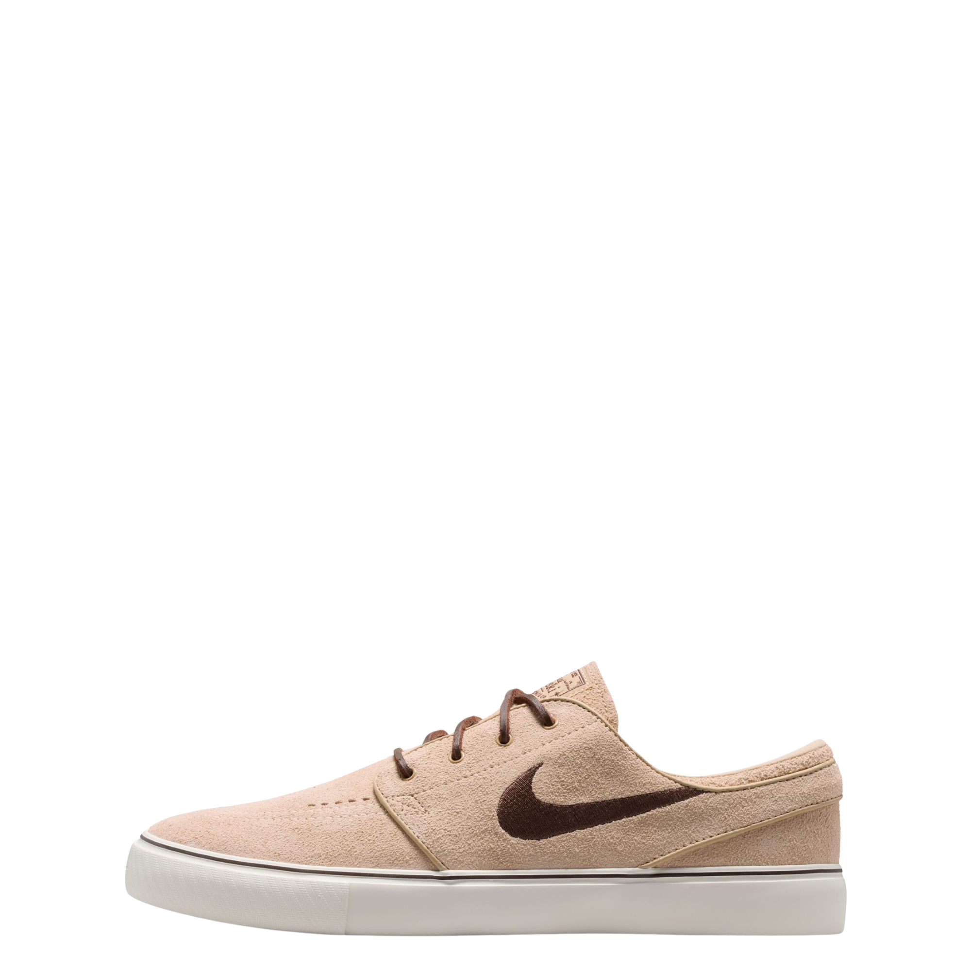 A Nike sb janoski low-top sneaker in a light beige suede and canvas mix, featuring a dark brown Swoosh logo, matching brown laces, and a thick white rubber sole.