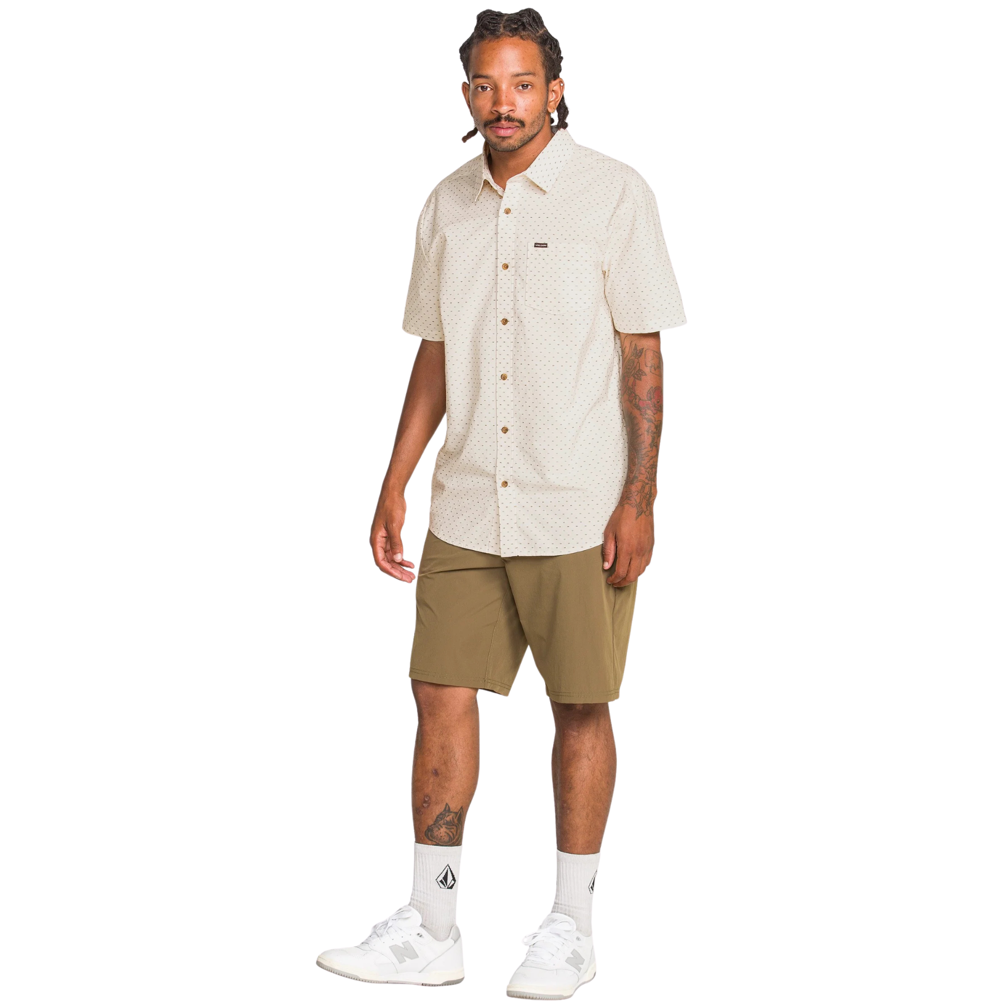 Man wearing a beige patterned volcom bankstone ii shirt on a white background