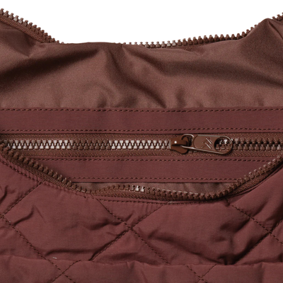 Brown quilted thread slouchy shoulder bag on a white background