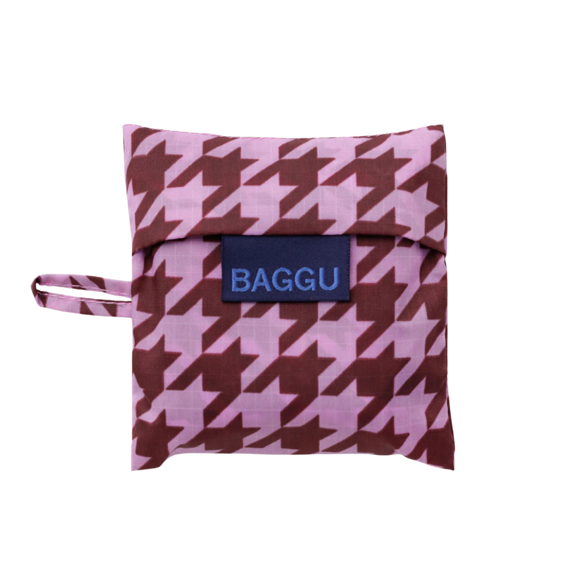 A small square fabric pouch with a pink and brown houndstooth pattern, featuring a navy blue brand label that reads 'BAGGU' and a matching handle on the left side, shown against a plain white background.