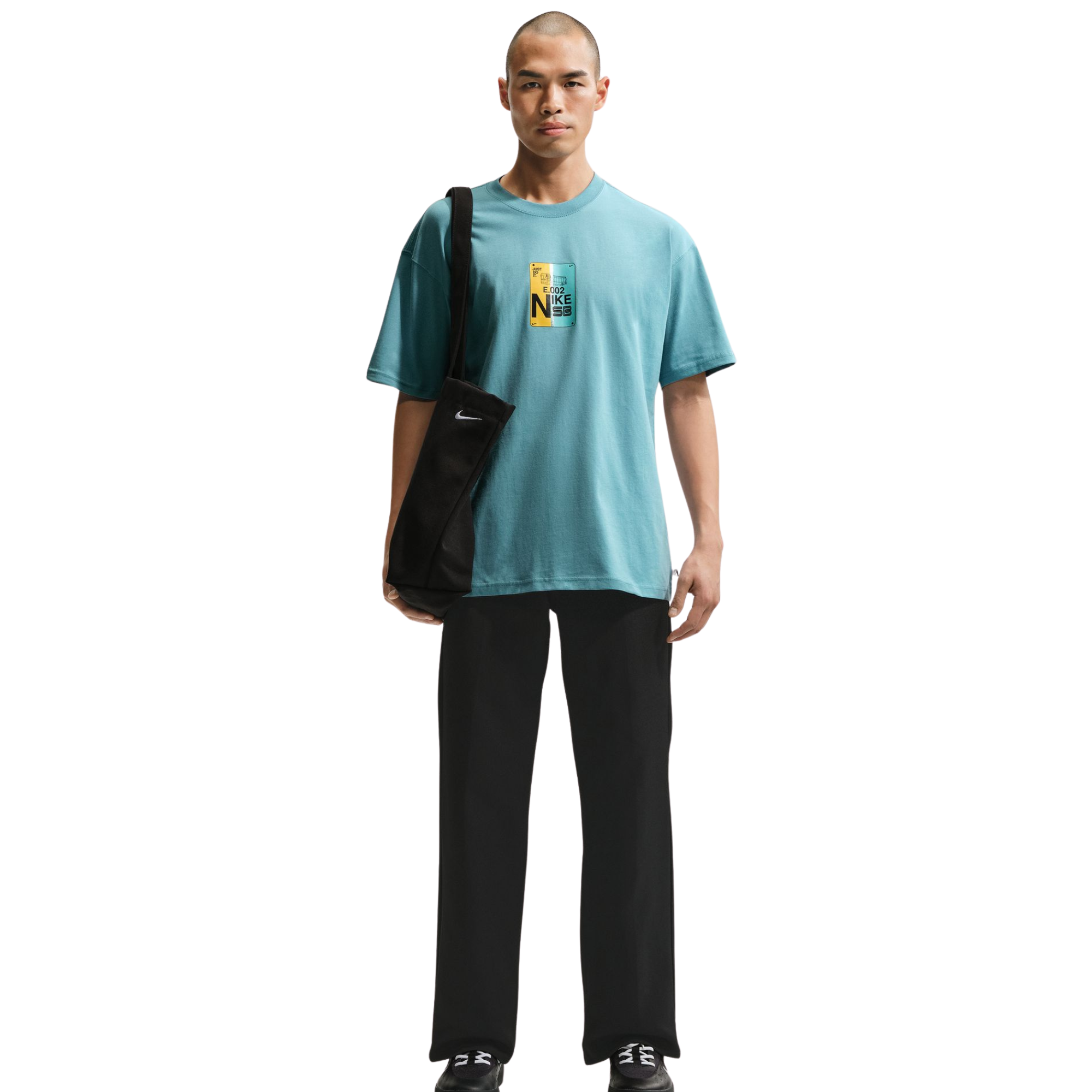 Man wearing a light blue t-shirt with a Nike logo on a white background