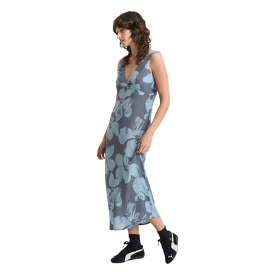 Woman wearing a sleeveless volcom grumpy sunshine floral dress on a white background