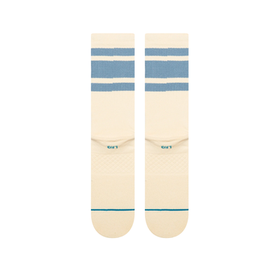 A pair of Stance got sol crew socks in cream with light blue horizontal stripes near the cuff, a small yellow logo on the side, and teal lettering on the toes, shown against a plain white background.