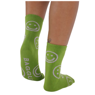 Green baggu crew socks with pink smiley face patterns on a white background