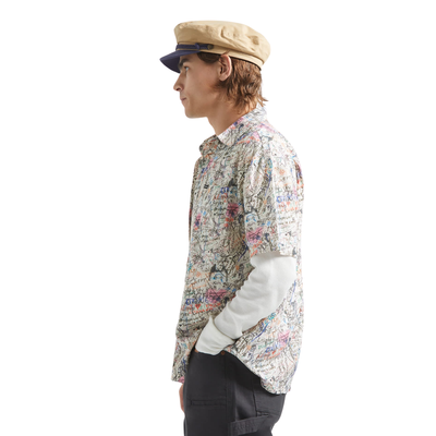 man wearing a brixton cru short sleeve woven shirt with graffiti pattern on a white background