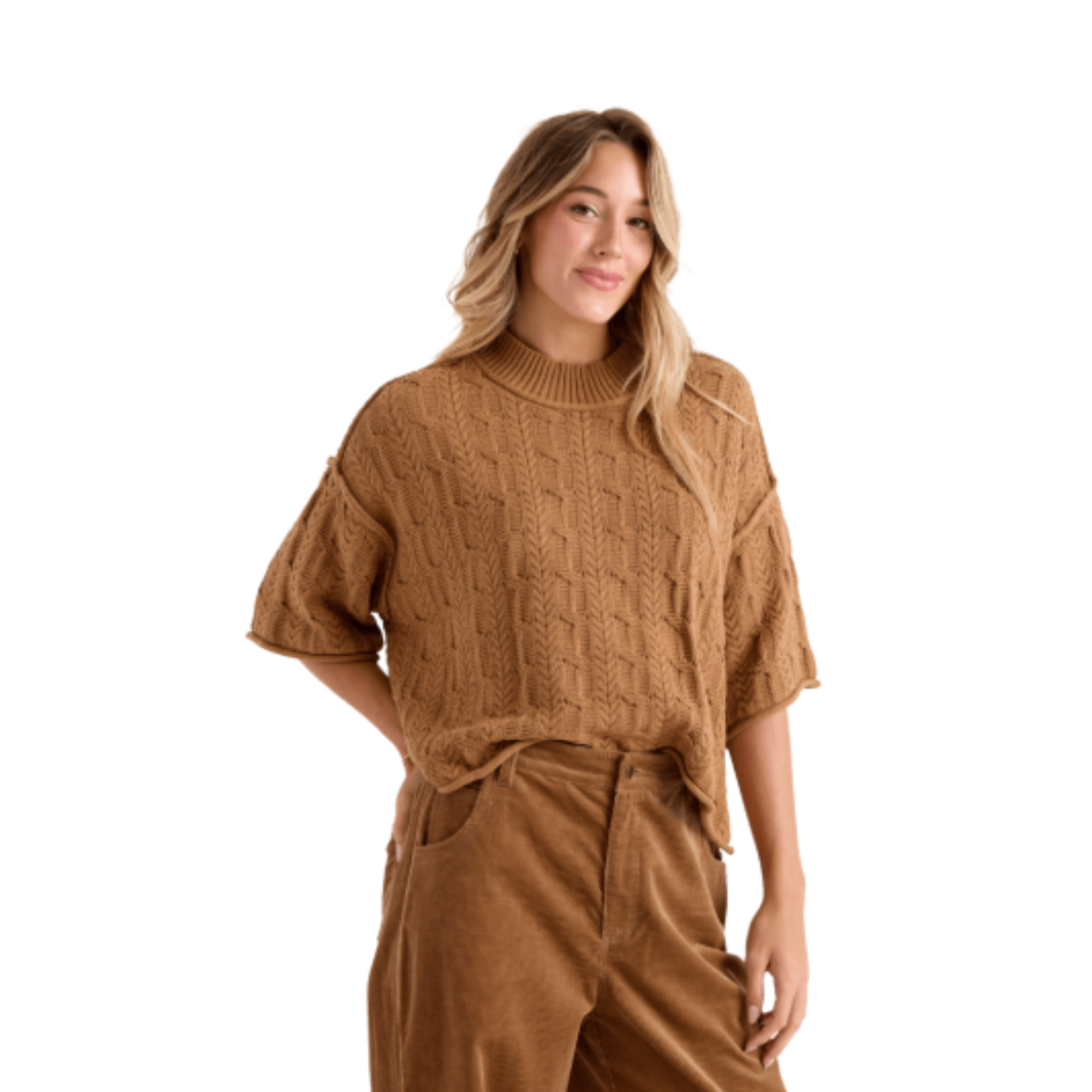 A woman wearing a brown volcom oversized cable-knit mock-neck sweater and matching brown corduroy pants, shown against a plain white background.