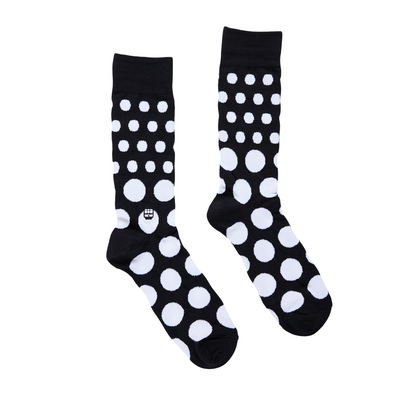 Black bonfolk socks with white polka dots on a white background