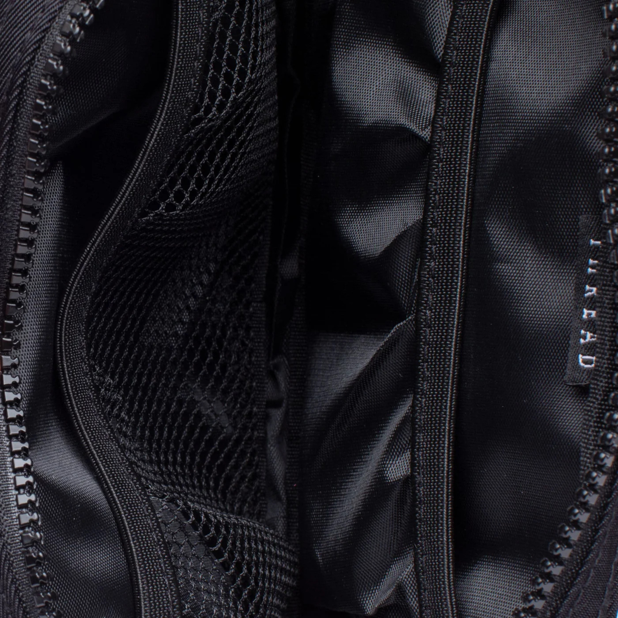 Black thread belt bag with a visible brand logo on a white background