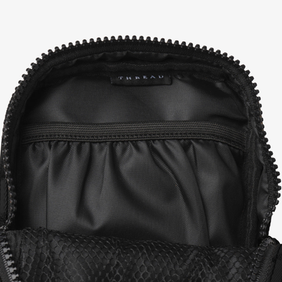 Black thread crossbody bag on a white background