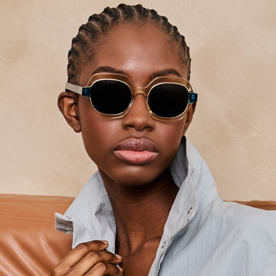 Person wearing Spitfire cut 133 Sunglasses with beige frame and dark lenses