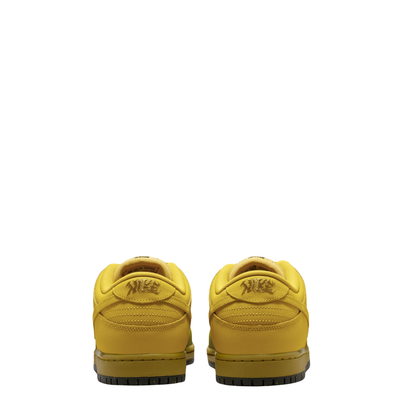 A Nike SB Saffron Dunk Low sneaker in a yellow, tan, and sage green colorway, against a plain white background.