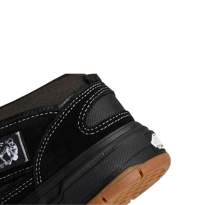 Black  vans united by skateboarding half cab mid-top sneaker with white laces on a white background