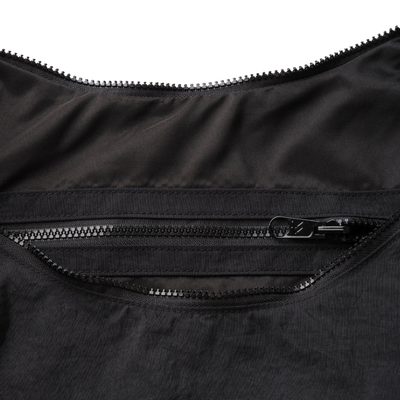 Black thread slouchy shoulder bag with a strap on a white background